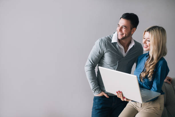 istock Smiling man and woman with a laptop 1036994650