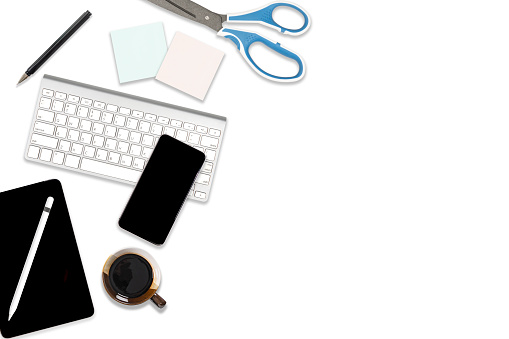 Flat lay photo of office table with laptop computer, digital tablet, mobile phone and accessories. on isolated white background. Desktop office mockup concept.