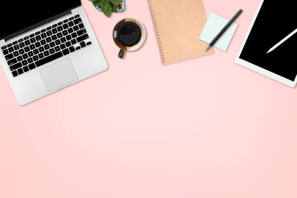 istock Flat lay photo of office table with laptop computer, digital tablet, mobile phone and accessories. on isolated pink background. Desktop office mockup concept. 1036995012
