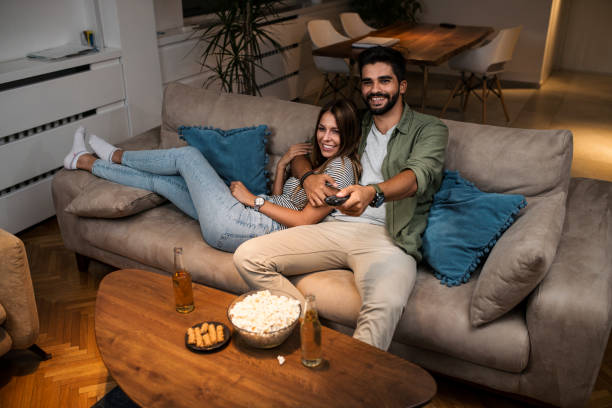istock Couple on Sofa Watching TV 1037004126