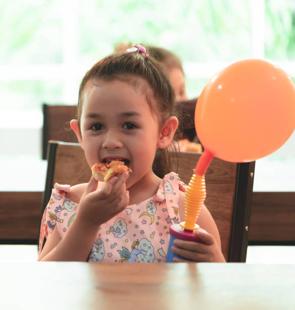 istock Happy Student kids is eating delivery pizza in classroom 1037004924