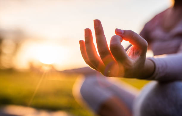 Close up of meditation in park at sunrise. Close up of yoga outdoor at sunset. meditation hands stock pictures, royalty-free photos & images