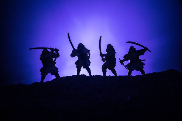 istock Medieval battle scene with cavalry and infantry. Silhouettes of figures as separate objects, fight between warriors on dark toned foggy background. Night scene. Selective focus 1037014172