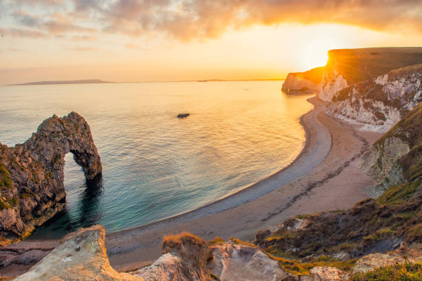Landscape of empty Durdle Door beach at Sunset. Dorset England. Landscape of empty Durdle Door beach at Sunset. Dorset England durdle door stock pictures, royalty-free photos & images