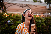 Smiling woman holding icecream.