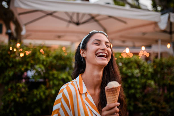 smiling woman holding icecream. - gelato imagens e fotografias de stock