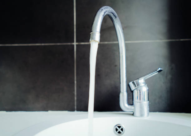 istock Metal tap with water closeup 1037026986