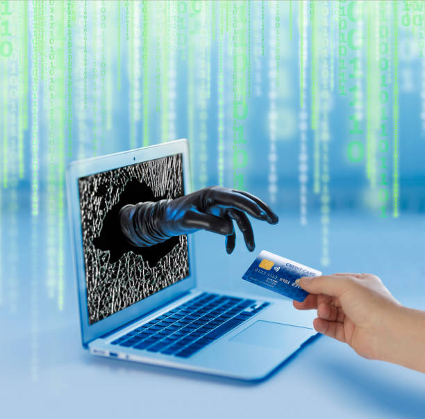 istock Computer Crime criminal stealing credit card from laptop in cyberspace 1037031390