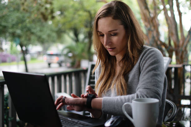 istock Woman Checking the Time on her Smart Watch While Working 1037040820