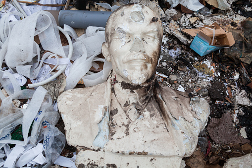 KYIV, UKRAINE -  FEBRUARY 28, 2016: Decommunization in Ukraine. Damaged bust of Lenin in the garbage dump.