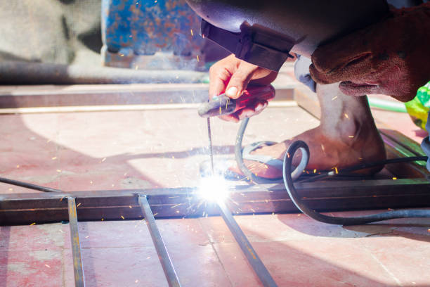 istock Industrial welder welding fabricated construction in factory Welding process by Shielded Metal Arc Welding or Stick Welding. 1037054014