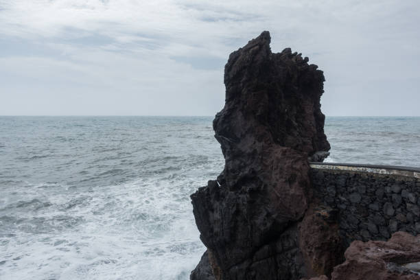 istock Rock end of Ponta do Sol pier bridge in Madeira 1037058718