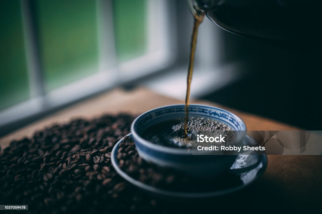 A cup of coffee being poured Coffee being poured 2015 Stock Photo