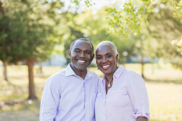 istock Mature couple outdoors at park, smiling 1037075442