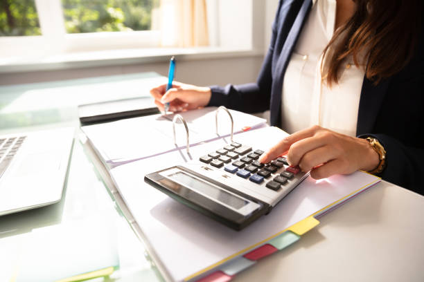 istock Businesswoman Calculating Invoice 1037076698