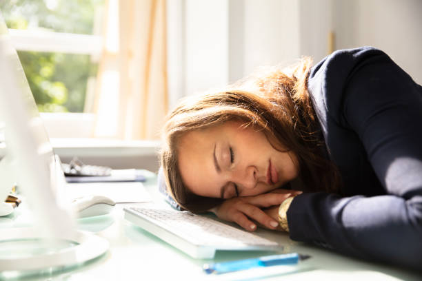 Businesswoman Sleeping In Office Close-up Of A Young Businesswoman Sleeping Over Desk narcolepsy stock pictures, royalty-free photos & images