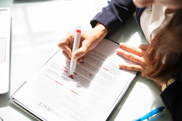 istock Businesswoman Marking Error In Contract Form 1037076748