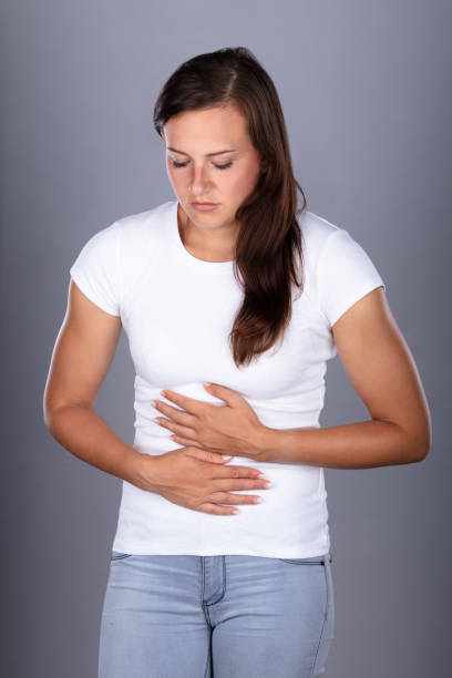 istock Young Woman Suffering From Stomach Pain 1037080314