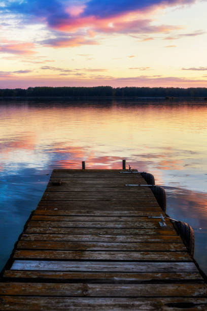 istock Beautiful Vibrant Pink And Blue Sunset With Wooden Jetty 1037081994