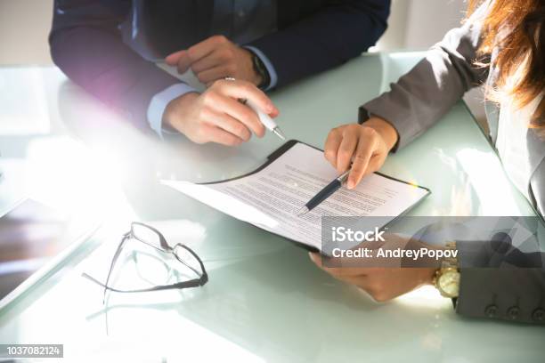 Two Businesspeople Analyzing Document Stock Photo - Download Image Now - Contract, Lawyer, Document