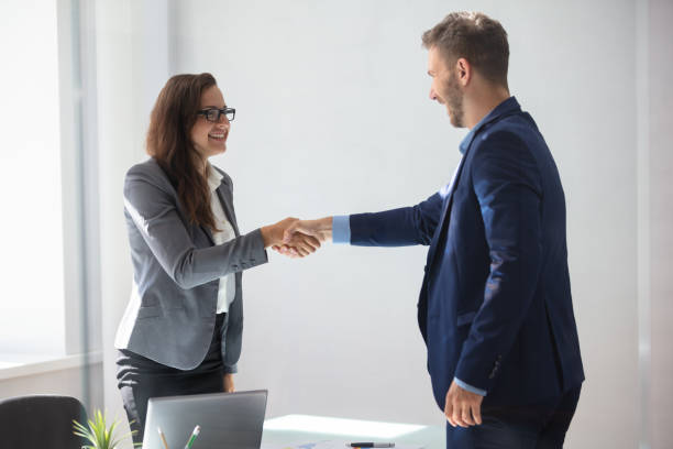 istock Businesswoman Shaking Hands With Her Partner 1037082258
