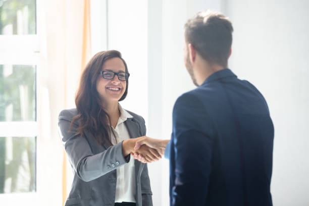 istock Businesswoman Shaking Hands With Her Partner 1037082340