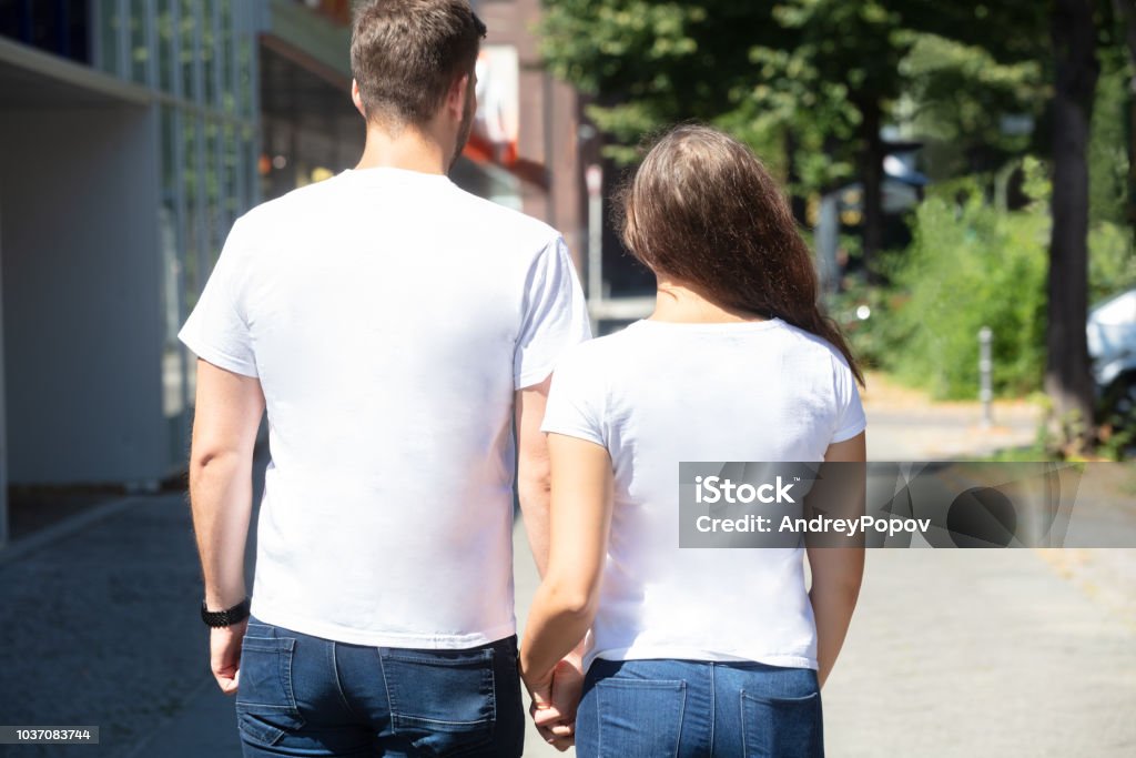 Rear View Of A Young Couple Rear View Of A Young Couple Standing On Street Back Stock Photo