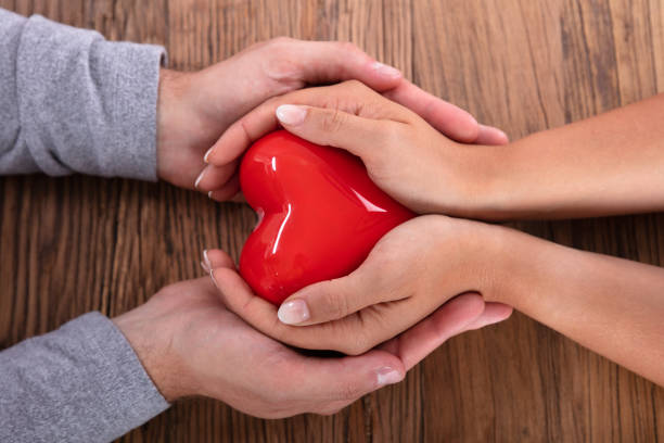istock Couple Holding Red Heart 1037085050