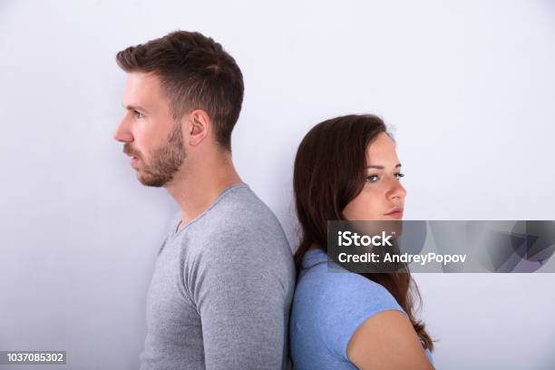 Unhappy Couple Standing Back To Back Stock Photo - Download Image Now - Adult, Adults Only, Anger
