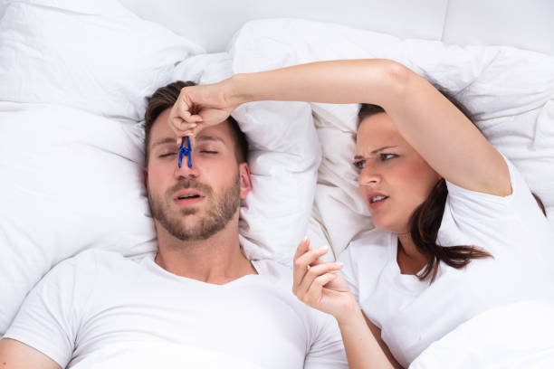 istock Woman Trying To Stop Man's Snoring With Clothespin 1037085430