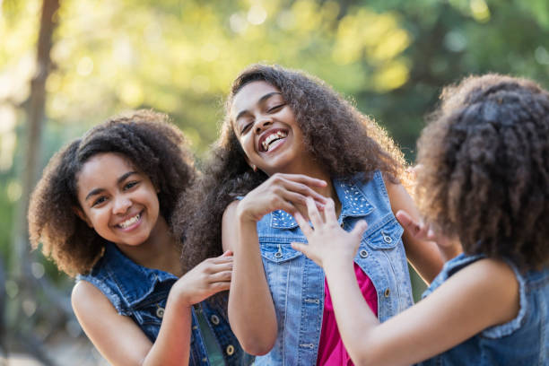 istock Three African-American sisters at a park, laughing 1037087274