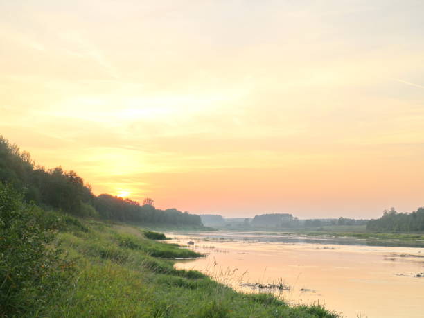 istock picturesque river bank at sunset 1037088060