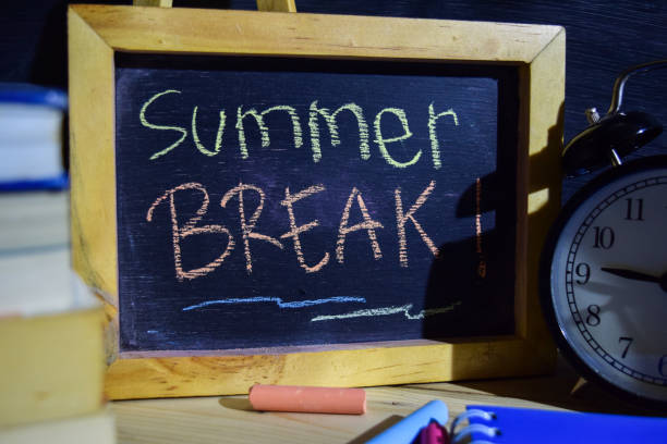 istock Summer break on phrase colorful handwritten on blackboard. 1037088398