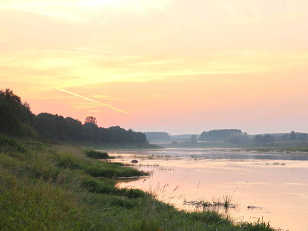 istock picturesque river bank at sunset 1037088574