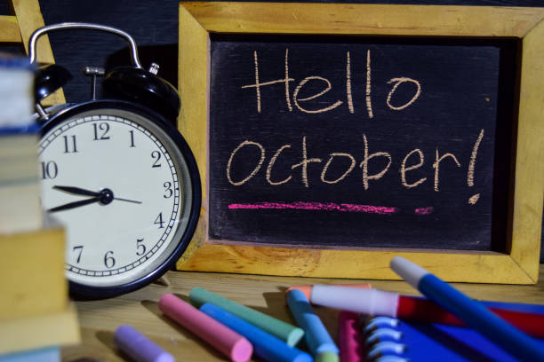 istock Hello october on phrase colorful handwritten on blackboard. 1037090558