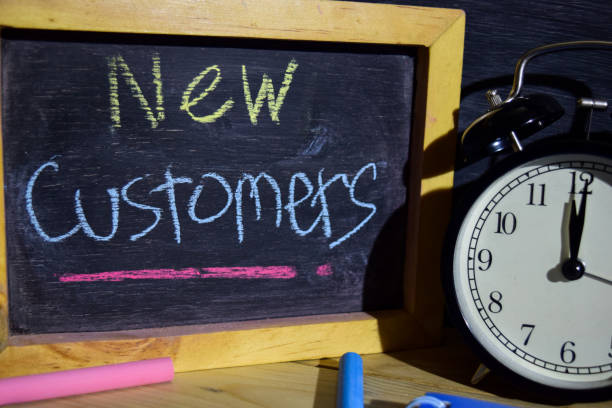 istock New Customers on phrase colorful handwritten on blackboard. 1037090770