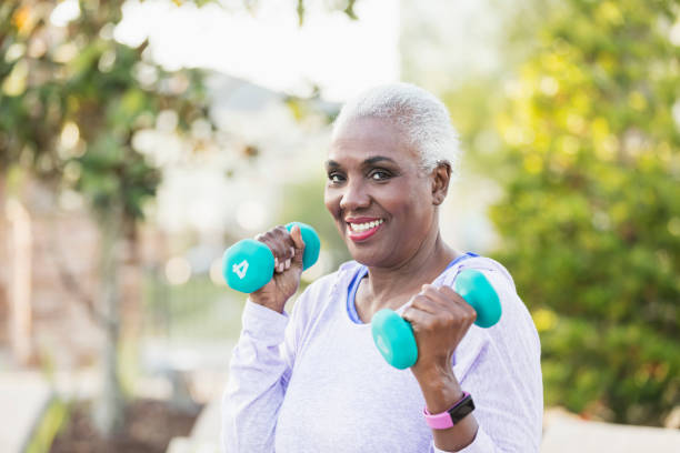 istock Senior African-American woman lifting hand weights 1037092680