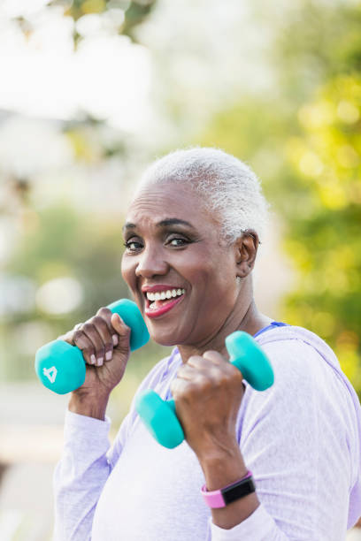 istock Senior African-American woman lifting hand weights 1037093048
