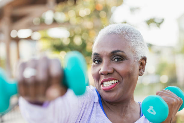 istock Senior African-American woman lifting hand weights 1037095564