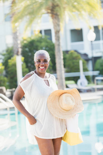 istock Senior African-American woman standing on pool deck 1037096498
