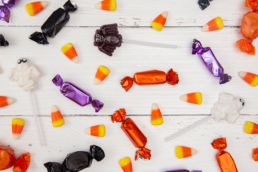 Halloween Candy Background on a White Wood Table