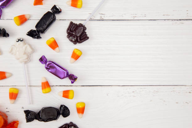 istock Halloween Candy Background on a White Wood Table 1037097594