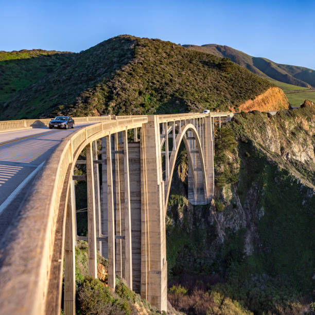 istock Arched Bixby Bridge and mountain on a sunny day 1037101624
