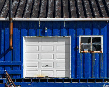 St. Anthony, Newfoundland, Canada -- July 31, 2018: Exterior of royal blue shed and garage on Moore's Drive in St. Anthony