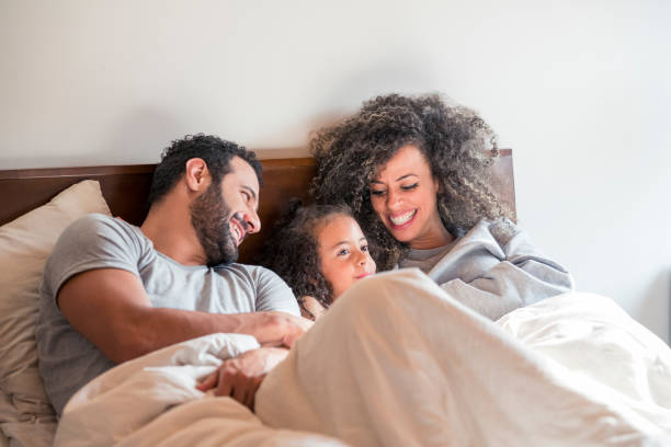 istock Dad, mom and daughter in bed 1037163208