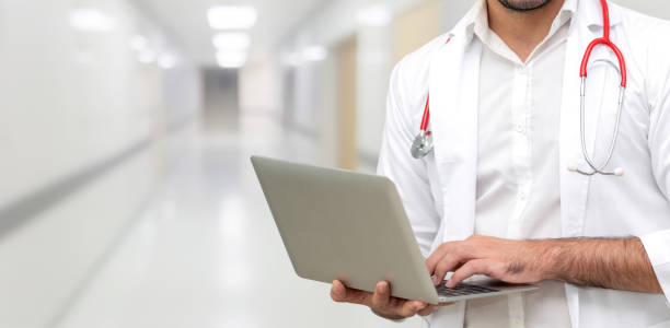 Doctor using laptop computer at the hospital.