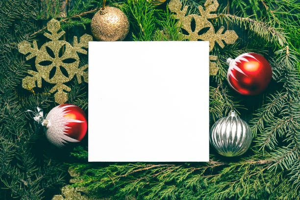 istock top flat lay layout of christmas decoration toys with empty white frame  on pine tree branches concept s 1037180160