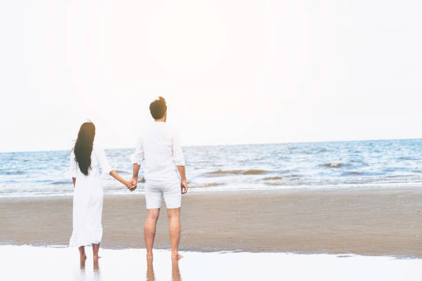 istock Couple going honeymoon on tropical beach in summer 1037180436