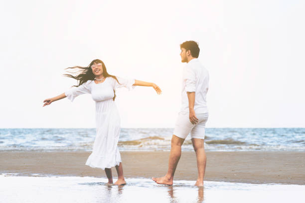 istock Couple going honeymoon on tropical beach in summer 1037180452