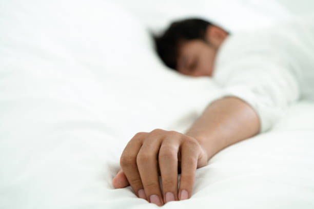 Young man sleep in bed in the bedroom.